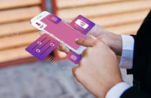 Businessman using a smartphone with digital financial app interface floating on the screen, managing credit card transactions and personal finance controls.